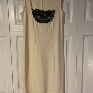 Venus cream color dress with black lace insert. Size small.